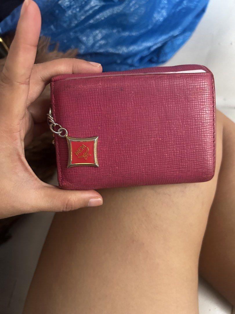 MCM Pink Leather Trifold Wallet (Category: Luxury Bags & Wallets) located in Cebu City. Submitted by yenetcuba52435 (Listing ID 1469507950, Image 3). Description: - Brand: MCM - Material: 100% Cow leather - Color: Pink with gold-tone hardware and red enamel accents - Design: Trifold wallet with multiple card slots, cash compartment, and ID window - Extras: Attached side chain charm with MCM logo - Inclusions: Original tag and care booklet - Condi