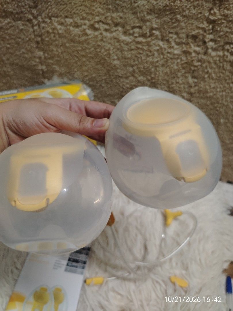 Medela Hands-free Collection Cups (Category: Breastfeeding & Bottle Feeding) located in Pulilan. Submitted by mjbabyproductsshop (Listing ID 1469470635, Image 2). Description: - Authentic Medela hands-free collection cups set with vibrant yellow accents - Includes two cups, connecting tubing, user manual, and original box - Allows discreet and hands-free pumping without holding bottles - Thoroughly cleaned, sanitized, and ready for immediate use 