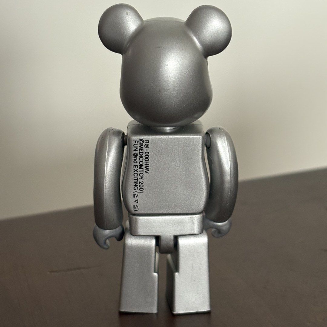 Medicom Toy Be@rbrick HMV Silver 100% (Category: Designer & Blind Box Toys) located in Manila. Submitted by aobacafe (Listing ID 1469456776, Image 2). Description: - Authentic Medicom Toy Be@rbrick (Dated 2001 stamped on back) - Rare silver finish with iconic HMV logo across the chest - Features a cute winking face design on the front - Stands firmly on its own.