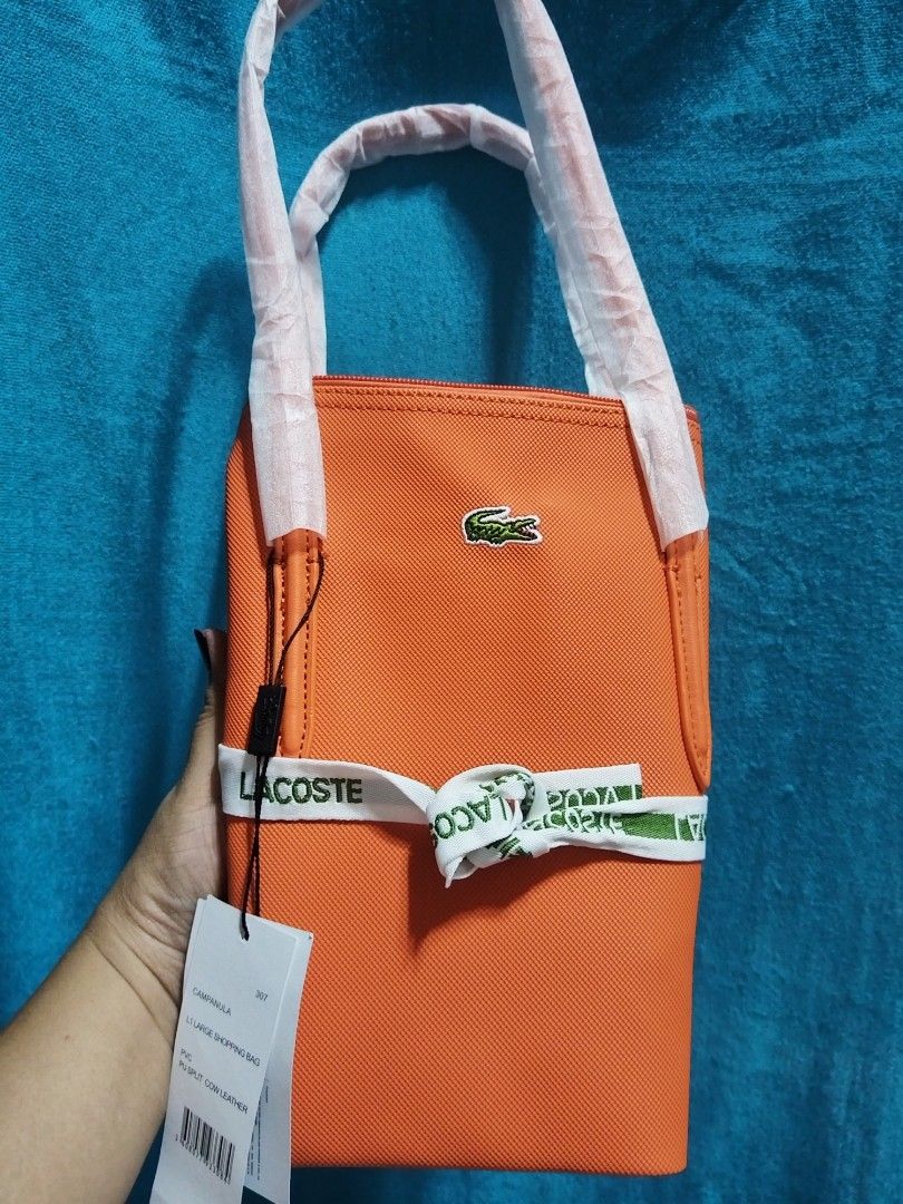 Mediun Tote L@coste Orange (Category: Tote Bags) located in Las Pinas. Submitted by jpmshoppe (Listing ID 1469465781, Image 2). Description: PVC leather medium tote bag Zipper closure in orange color.