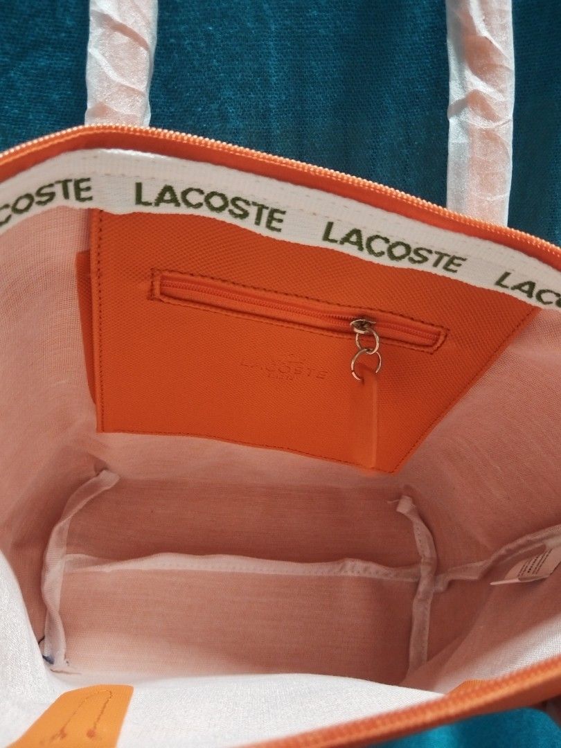 Mediun Tote L@coste Orange (Category: Tote Bags) located in Las Pinas. Submitted by jpmshoppe (Listing ID 1469465781, Image 3). Description: PVC leather medium tote bag Zipper closure in orange color.