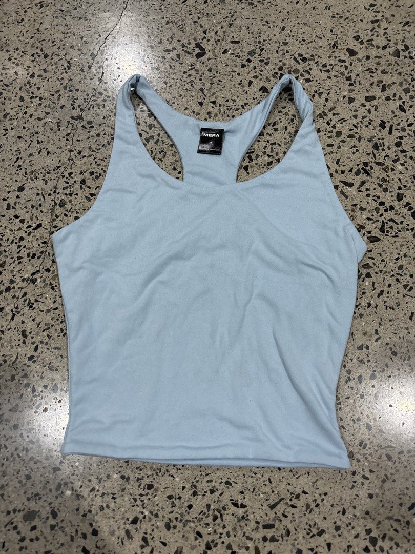 MERA Light Blue Racerback Tank Top (Category: Sleeveless) located in Manila. Submitted by everythingwlove (Listing ID 1469482416, Image 1). Description: - Brand: MERA - Size: XS - Color: Solid light blue - Style: Scoop neckline, racerback - Material: Soft and stretchy fabric - Condition: Clean neckline and straps - Ideal for: Everyday casual wear or gym workouts.