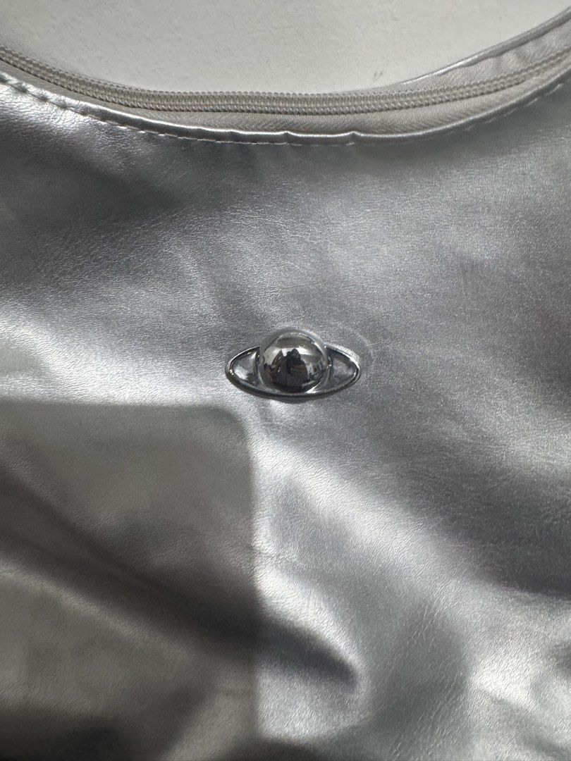 Metallic Silver Shoulder Bag with Planet Embellishment (Category: Shoulder Bags) located in Imus. Submitted by budolfindsimus (Listing ID 1469504036, Image 2). Description: 🪐 Y2K SILVER HOBO BAG - TRENDING PLANET CHARM! ✨ 2-WAY BAG - HOBO & bag pack Ang ganda sis! Pang Gen Z, pang tita, pang awra! 😍 DETAILS: Style: 2-WAY - Hobo Shoulder Bag + bag pack Material: Premium Faux Leather / Metallic Vegan Leather Shiny Silver - kumikinang talaga sa pe