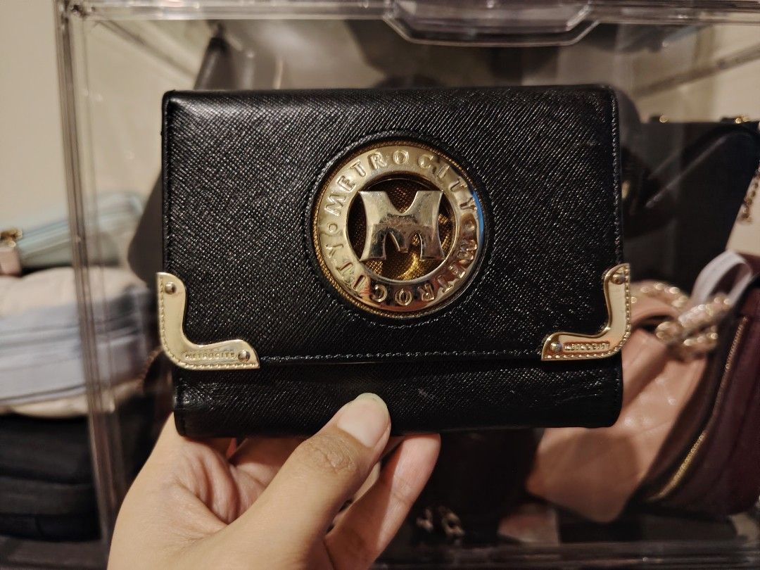 Metrocity Black Tri-fold Wallet with Gold Hardware (Category: Luxury Bags & Wallets) located in Quezon City. Submitted by chantillycee (Listing ID 1469471739, Image 1). Description: expects signs of use: - minimal fading/hairline sa hardware, gold pa - wala naman gaano scratch or rubs sa body - malinis, no foul smell - overall ok pa condition 8.5/10 qc.