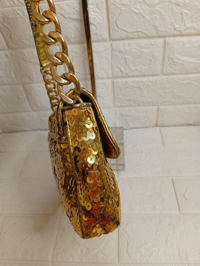 Michael Kors Gold Sequin Shoulder Bag with Chain Strap (Category: Shoulder Bags) located in Las Pinas. Submitted by etoksi1234 (Listing ID 1469557843, Image 3). Description: Pre-loved Michael Kors Gold Sequin Flap Shoulder Bag featuring an all-over gold sequin body, a center vertical accent, a prominent circular "MK" logo medallion on the magnetic flap, and a metallic chain and leather shoulder strap..