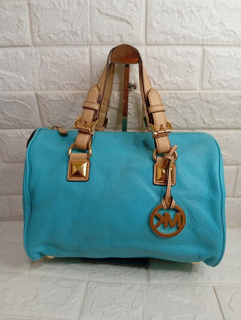 Michael Kors Grayson Medium Satchel Bag (Category: Shoulder Bags) located in Las Pinas. Submitted by etoksi1234 (Listing ID 1469558429, Image 1). Description: Pre-loved Michael Kors Grayson Medium Satchel in an aquamarine or turquoise leather finish, accented with gold-tone hardware, square stud details, dual top handles, and a signature hanging "MK" circular logo charm..
