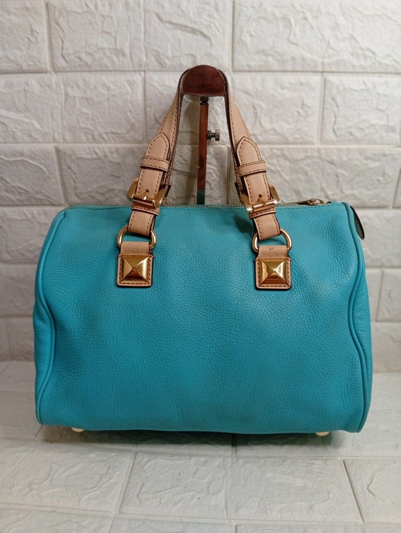 Michael Kors Grayson Medium Satchel Bag (Category: Shoulder Bags) located in Las Pinas. Submitted by etoksi1234 (Listing ID 1469558429, Image 2). Description: Pre-loved Michael Kors Grayson Medium Satchel in an aquamarine or turquoise leather finish, accented with gold-tone hardware, square stud details, dual top handles, and a signature hanging "MK" circular logo charm..