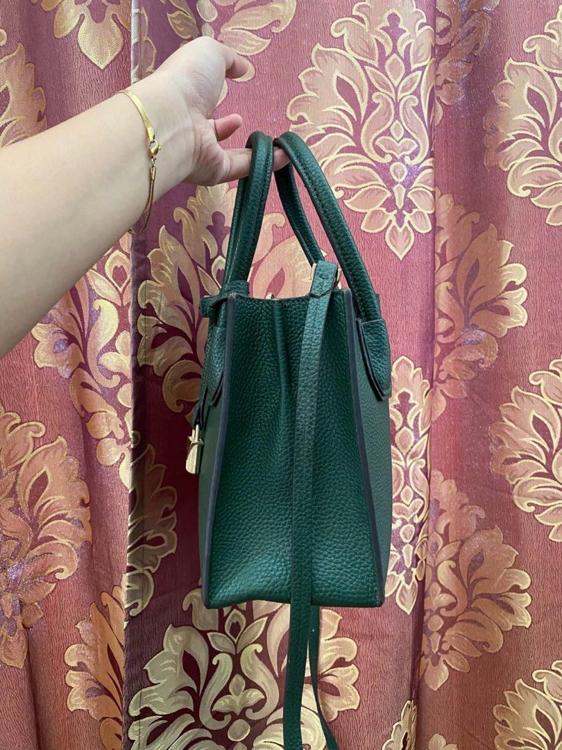Michael Kors Green Leather Handbag with Strap (Category: Luxury Bags & Wallets) located in Manila. Submitted by melissatua68314 (Listing ID 1469520773, Image 3). Description: - Brand: Michael Kors - Material: Premium deep green pebble leather - Hardware: Elegant gold-tone with signature padlock charm - Carry Options: Double top handles and a detachable shoulder strap - Interior: Secure middle zip compartment with slip and zip pockets - Size: Comp