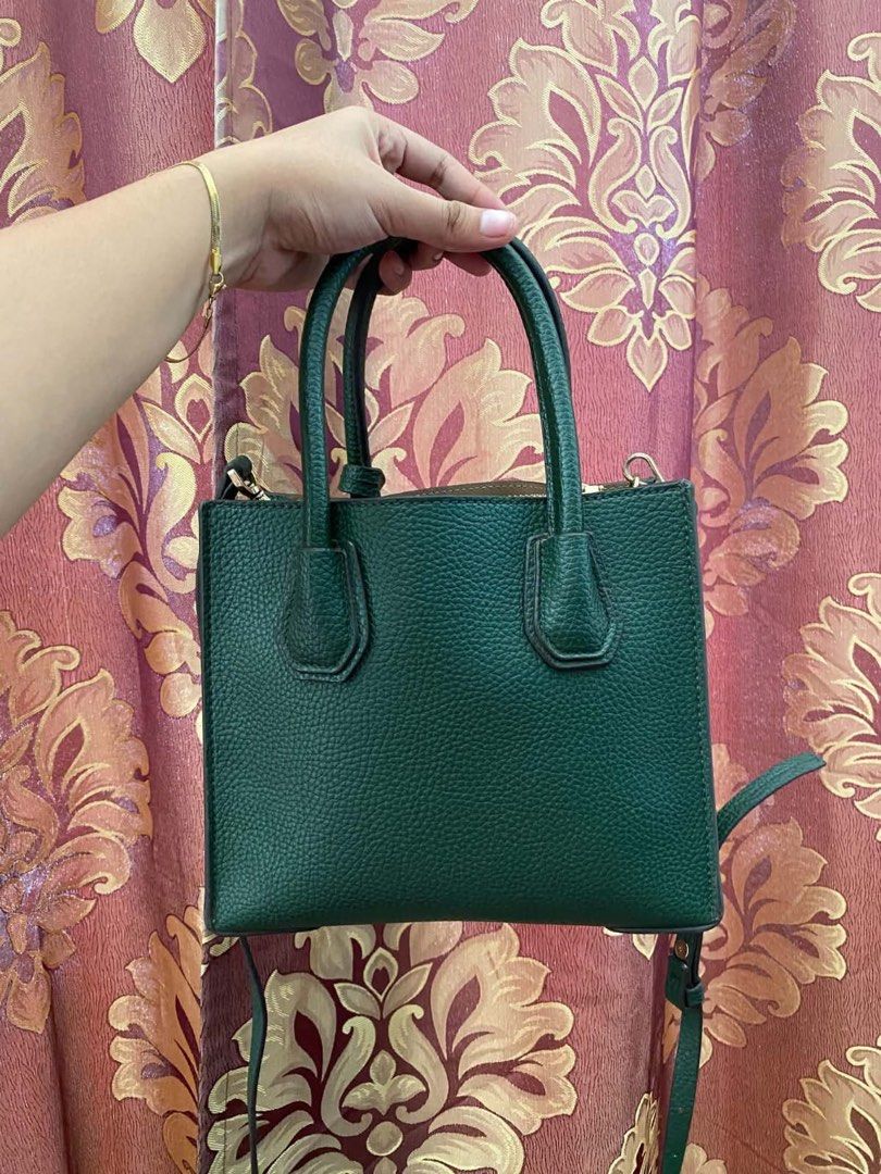 Michael Kors Green Leather Handbag with Strap (Category: Luxury Bags & Wallets) located in Manila. Submitted by melissatua68314 (Listing ID 1469520773, Image 2). Description: - Brand: Michael Kors - Material: Premium deep green pebble leather - Hardware: Elegant gold-tone with signature padlock charm - Carry Options: Double top handles and a detachable shoulder strap - Interior: Secure middle zip compartment with slip and zip pockets - Size: Comp
