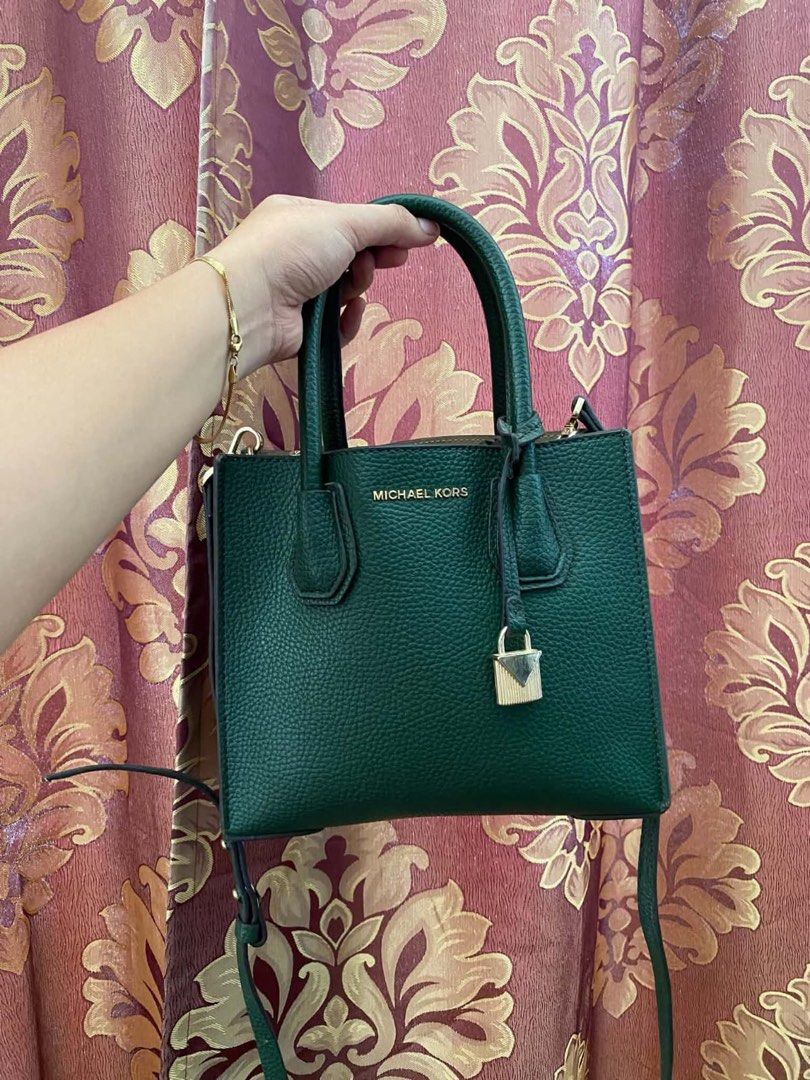 Michael Kors Green Leather Handbag with Strap (Category: Luxury Bags & Wallets) located in Manila. Submitted by melissatua68314 (Listing ID 1469520773, Image 1). Description: - Brand: Michael Kors - Material: Premium deep green pebble leather - Hardware: Elegant gold-tone with signature padlock charm - Carry Options: Double top handles and a detachable shoulder strap - Interior: Secure middle zip compartment with slip and zip pockets - Size: Comp