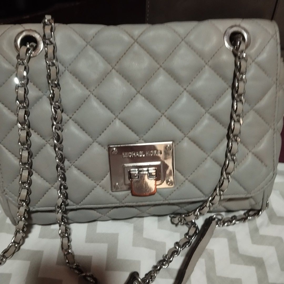 Michael Kors Handbag Collection (Category: Cross-body Bags) located in Manila. Submitted by lene48 (Listing ID 1469411971, Image 3). Description: Three handbags available here. One grey quilted shoulder bag with chain straps and Michael Kors lock. One light blue structured handbag with black trim and gold clasp. One two-toned brown and maroon structured bag with top handle. Grab them individually or together.3 for 500, flaw sign of use, clean ins