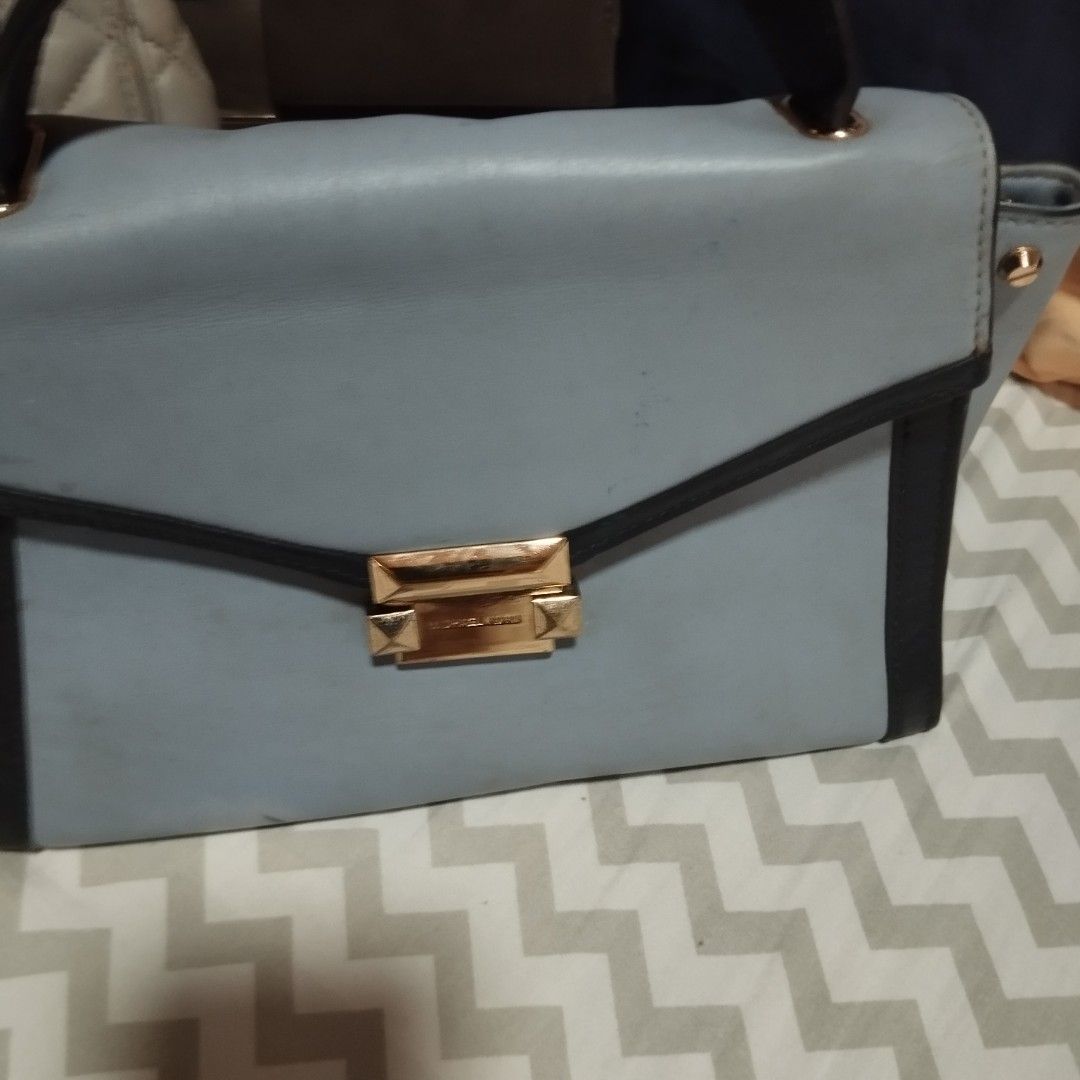 Michael Kors Handbag Collection (Category: Cross-body Bags) located in Manila. Submitted by lene48 (Listing ID 1469411971, Image 2). Description: Three handbags available here. One grey quilted shoulder bag with chain straps and Michael Kors lock. One light blue structured handbag with black trim and gold clasp. One two-toned brown and maroon structured bag with top handle. Grab them individually or together.3 for 500, flaw sign of use, clean ins