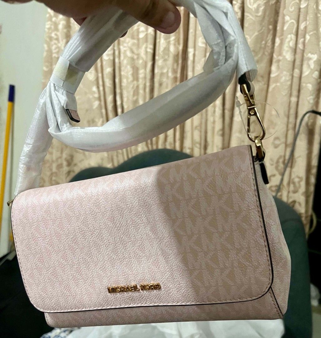 Michael Kors Jet Set Light Ceossbody Bag (Category: Luxury Bags & Wallets) located in Cebu City. Submitted by jomjomhernando31-16115 (Listing ID 1469550331, Image 1). Description: - Brand: Michael Kors - Style: Jet Set Item Medium Convertible Pouchette (Style No: 35F3GTTU2B) - Colorway: Light Powder Blush pink with signature MK monogram print - Hardware: Gold-tone - Condition: Brand new with original store tag attached - Strap: Removable and adju