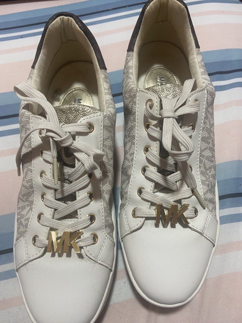 Michael Kors MK Logo White Sneakers (Category: Sneakers) located in Las Pinas. Submitted by 22nellie28 (Listing ID 1469519520, Image 2). Description: - Brand: Michael Kors - Color: White with all-over MK monogram pattern and brown heel accent - Hardware: Premium gold-tone lace hardware with MK letter charms - Soles: Thick white platform soles with debossed Michael Kors lettering - Laces: Flat, woven white laces - Condition: Excellent / Ready to w