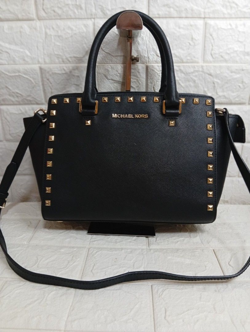 Michael Kors Selma Stud Medium Satchel Bag (Category: Cross-body Bags) located in Las Pinas. Submitted by etoksi1234 (Listing ID 1469558297, Image 1). Description: Michael Kors Selma Stud medium satchel Bag. Crafted from structured Saffiano leather with gold-tone pyramid stud accents, dual top handles, and a detachable shoulder strap..