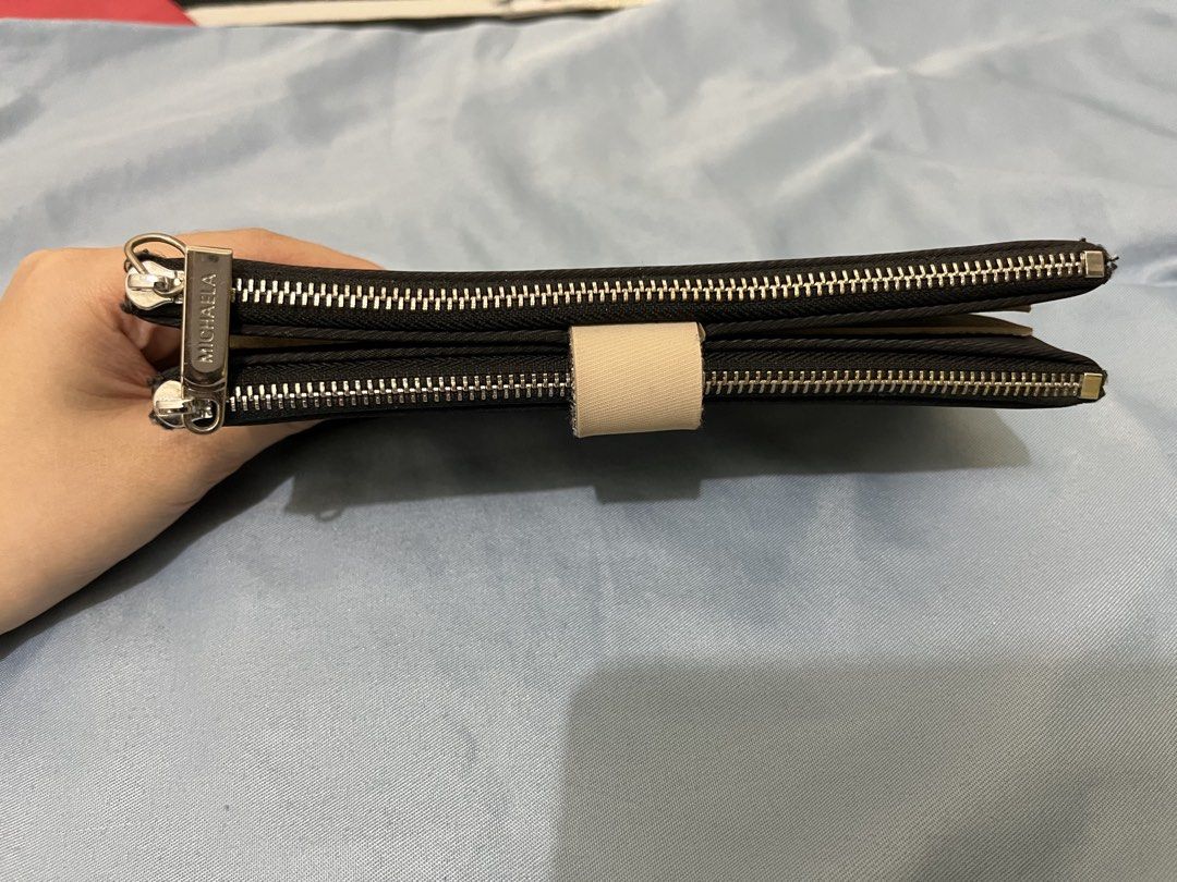 Michaela Black Double Zipper Wallet (Category: Wallets & Card holders) located in Angeles City. Submitted by melloromi (Listing ID 1469551342, Image 3). Description: Condition: -still in good condition -has washable stain -peeling on some inner card slots due to wear and tear. Still usable..