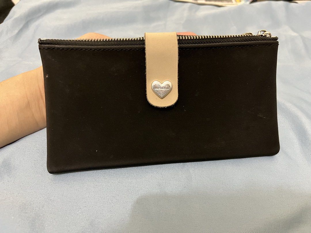 Michaela Black Double Zipper Wallet (Category: Wallets & Card holders) located in Angeles City. Submitted by melloromi (Listing ID 1469551342, Image 2). Description: Condition: -still in good condition -has washable stain -peeling on some inner card slots due to wear and tear. Still usable..