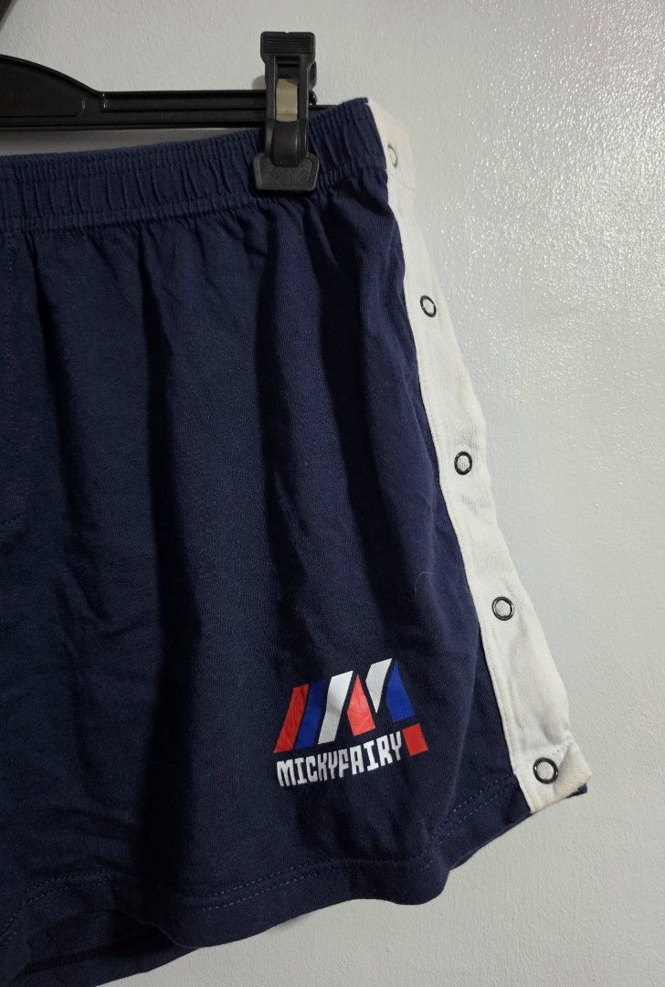 Mickyfairy Navy Blue Button Side Athletic Shorts (Category: Shorts) located in Paranaque City. Submitted by franinnashop (Listing ID 1469525380, Image 2). Description: Declutter - Brand: Mickyfairy - Color: Navy blue with white side panels and colorful logo on the left hem - Design: Trendy snap-button closures down both legs - Material: Comfortable and breathable cotton - Waist: Elastic with stretch, fits 30 to 36 inches - Length: 11 inches - Sty