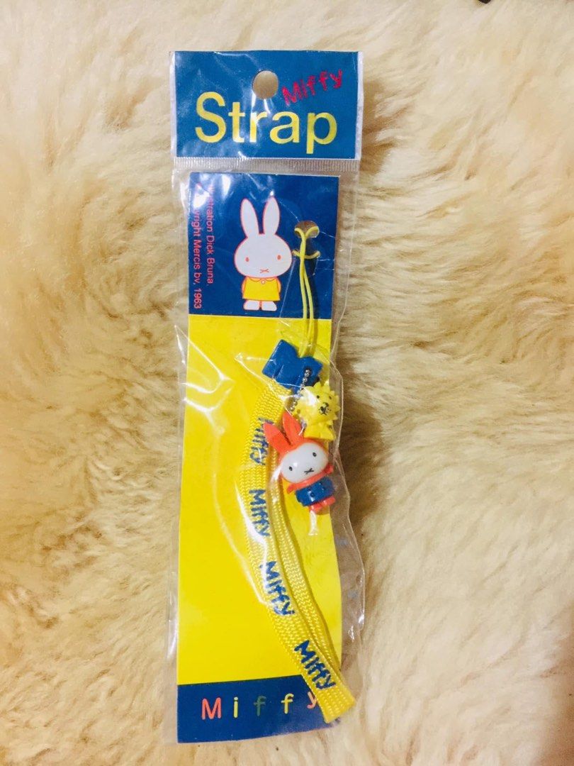 Miffy Strap Yellow Blue Orange Character Charm Phone Strap (Category: Character Goods) located in Baguio. Submitted by izza_thrifty (Listing ID 1469403514, Image 1). Description: - 100% authentic Miffy merchandise in original unopened packaging - Vibrant yellow woven lanyard with stylish blue Miffy text - Includes 3 cute charms: blue 'M' symbol, yellow lion, and orange-suited Miffy figurine - Official Dick Bruna Mercis bv (1963 copyright) collect