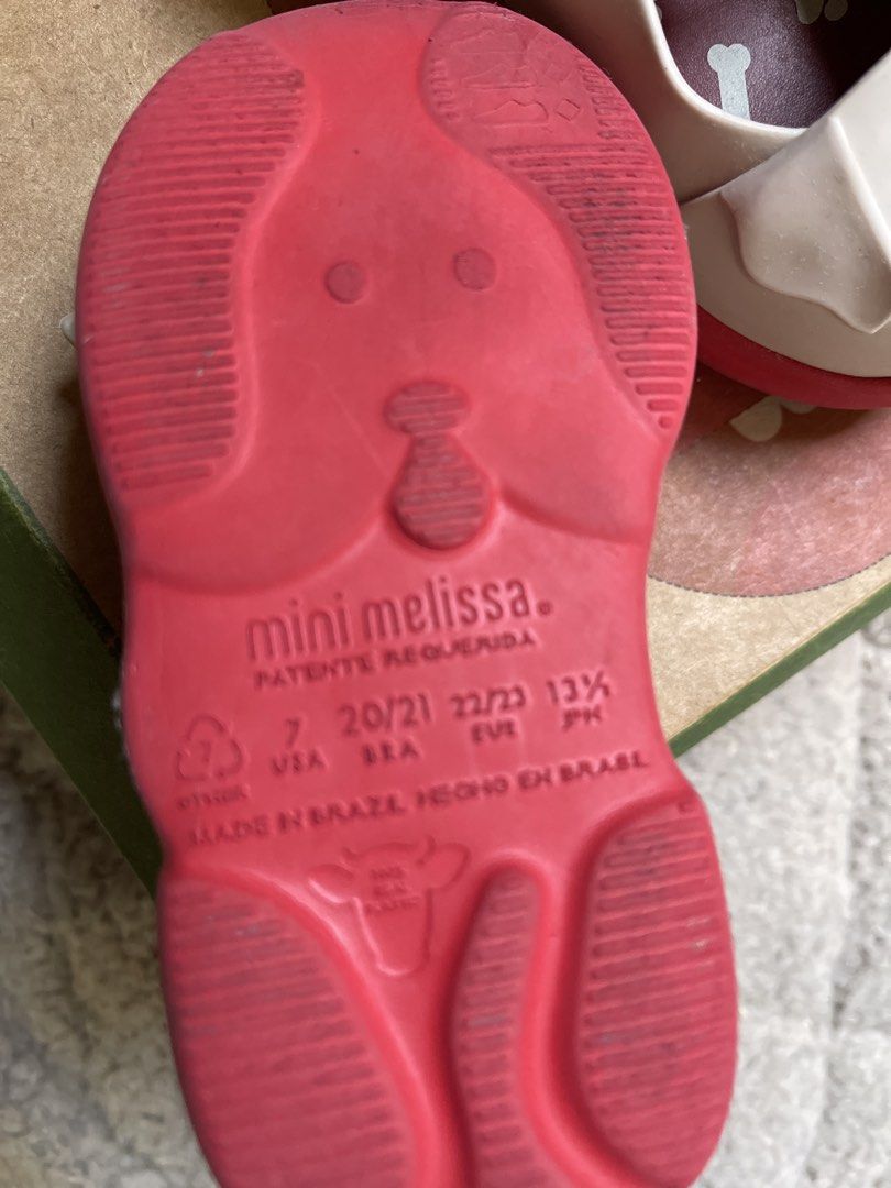 Mini Melissa Dog Shoes Toddler Size 7 (Category: Babies & Kids Fashion) located in Cavite. Submitted by sjlav (Listing ID 1469468236, Image 3). Description: - Authentic Mini Melissa toddler shoes made in Brazil - Cream and red colorway with adorable puppy face design and 3D floppy ears - Fun bone and paw print pattern on the red insoles - Secure and adjustable ankle strap with buckle closure - Includes original green and brown box .