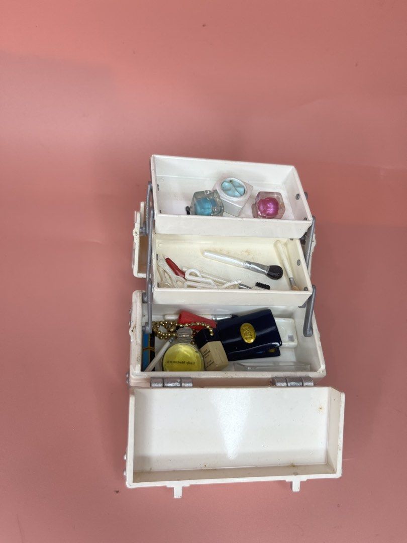 Miniature Toy Makeup Vanity Case with Accessories (Category: Kids Toys) located in Caloocan City. Submitted by snapshop_ph (Listing ID 1469438863, Image 1). Description: - Miniature white cosmetic train case with pull-out tiers - Includes tiny pretend makeup, brushes, and accessories - Features secure closure, handle, and silver hardware - Perfect retro toy for dollhouses or miniature collectors - Condition: Normal signs of age and play wear thro