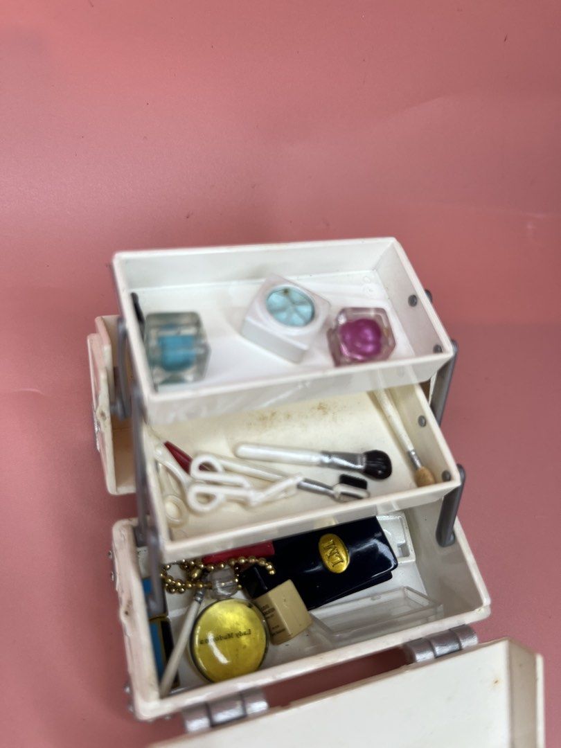 Miniature Toy Makeup Vanity Case with Accessories (Category: Kids Toys) located in Caloocan City. Submitted by snapshop_ph (Listing ID 1469438863, Image 2). Description: - Miniature white cosmetic train case with pull-out tiers - Includes tiny pretend makeup, brushes, and accessories - Features secure closure, handle, and silver hardware - Perfect retro toy for dollhouses or miniature collectors - Condition: Normal signs of age and play wear thro