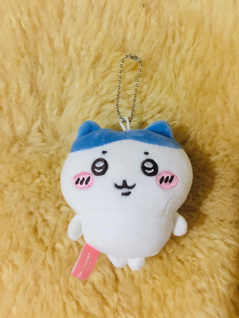 Miniso Chiikawa Hachiware Plush Keychain Bag Charm (Category: Plushies & Soft Toys) located in Baguio. Submitted by izza_thrifty (Listing ID 1469567414, Image 1). Description: - Official Miniso x Chiikawa collaboration plush keychain - Character: Hachiware (white body with blue cat ears and embroidered blush) - Includes silver-coloured ball chain for easy hanging on bags or keys - Features official Miniso and Chiikawa branding tag on the side - C