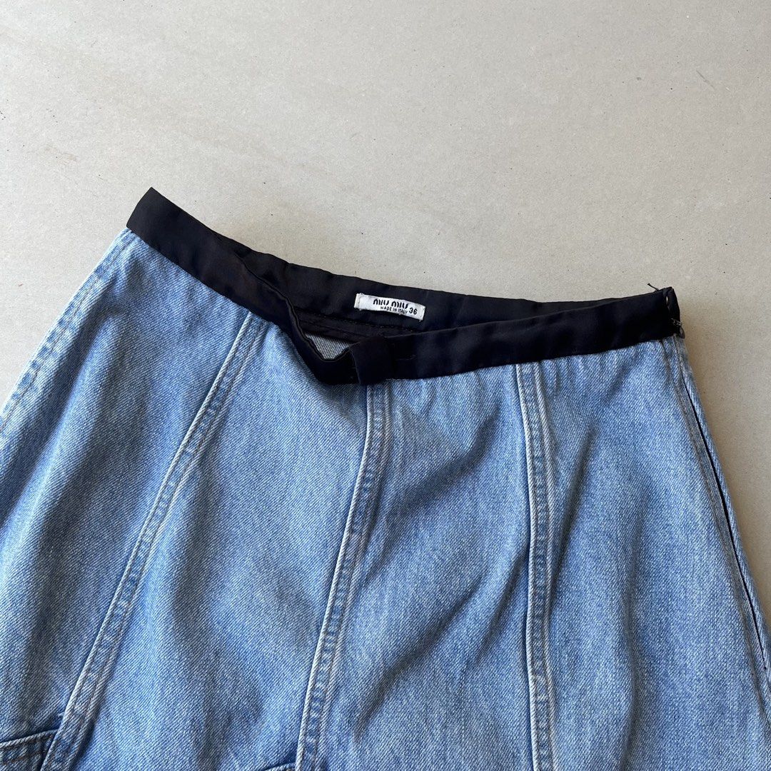 Miu Miu Denim Skirt (Category: Skirts) located in Mandaue City. Submitted by chinsyap_03 (Listing ID 1469468561, Image 3). Description: - Brand: Miu Miu - Origin: Made in Italy - Size: 36 - Wash: Light wash denim - Details: Contrast black waistband, panelled construction, raw frayed hem - Closure: Side zip - Style: Classic vintage piece, highly versatile and easy to pair with tees or knits.