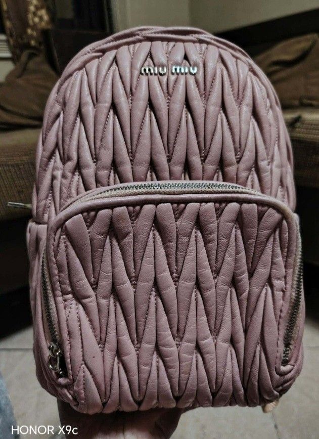Miu Miu Quilted Pink Leather Backpack (Category: Luxury Bags & Wallets) located in Bay. Submitted by silverhorse-59c851 (Listing ID 1469396393, Image 1). Description: - Brand: Miu Miu - Material: Premium pink leather with signature matelassé quilting - Hardware: Silver-tone with metal lettering logo on the front - Storage: Main compartment with secure zip closure + convenient front zipped pocket - Details: Branded zipper pullers - Style: Compact 