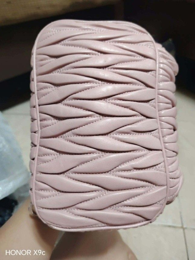 Miu Miu Quilted Pink Leather Backpack (Category: Luxury Bags & Wallets) located in Bay. Submitted by silverhorse-59c851 (Listing ID 1469396393, Image 2). Description: - Brand: Miu Miu - Material: Premium pink leather with signature matelassé quilting - Hardware: Silver-tone with metal lettering logo on the front - Storage: Main compartment with secure zip closure + convenient front zipped pocket - Details: Branded zipper pullers - Style: Compact 