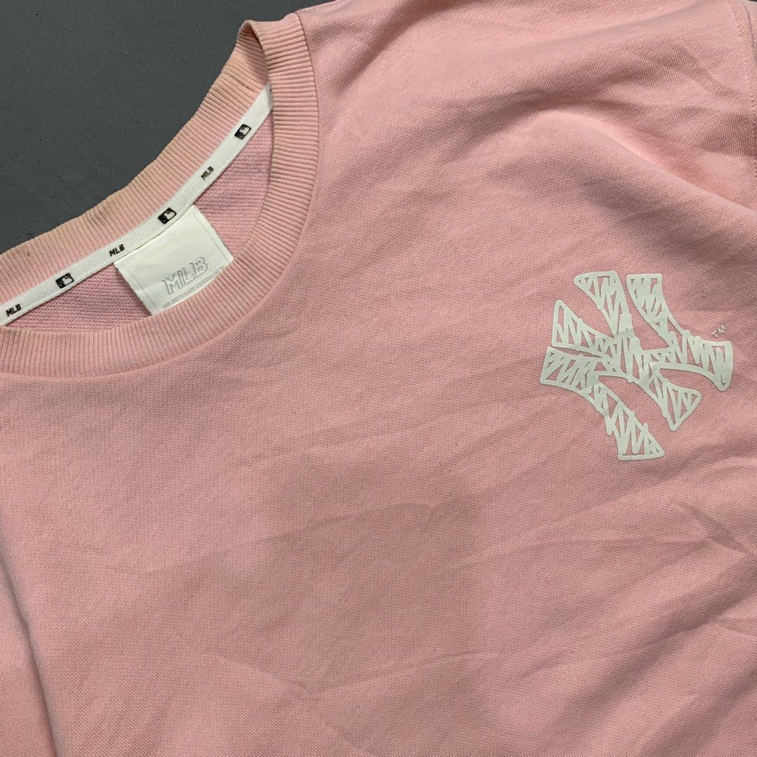 MLB New York Yankees Pink Sweatshirt (Category: Coats, Jackets and Outerwear) located in Kalibo. Submitted by gneiss2002 (Listing ID 1469528476, Image 3). Description: - Authentic pink MLB New York Yankees sweatshirt - Classic crewneck design with ribbed collar, cuffs, and hem - Small textured embroidered NY logo on the left chest - Soft cotton blend interior for everyday warmth and comfort - Relaxed fit through the body and sleeves.