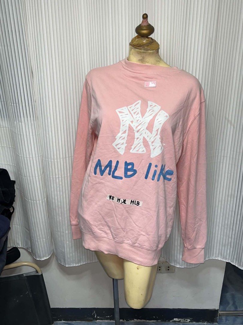 MLB Pink Yankees Crewneck Sweatshirt (Category: Coats, Jackets and Outerwear) located in General Trias. Submitted by crissy9053136 (Listing ID 1469446018, Image 2). Description: - Color: Pink - Brand/Team: New York Yankees (MLB) - Design: Small logo on chest, large graphic and lettering on the back - Fit: Relaxed, oversized fit - Material: Cozy fleece - Style: Casual and easy to style.
