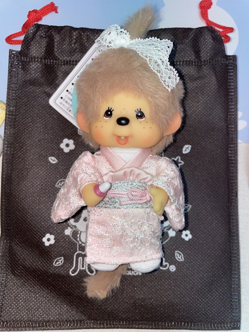 Monchhichi milktea brown pink kimono (Category: Plushies & Soft Toys) located in Antipolo. Submitted by almm15 (Listing ID 1469554485, Image 1). Description: - Wears a charming pink floral kimono with a matching delicate lace head bow - Holding an adorable miniature pink baby bottle - Features soft brown fluffy fur, sweet freckled cheeks, and white shoes - Clean and well-kept, great addition to any collection - Fast shipping and careful packaging