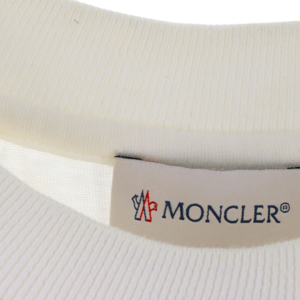 Moncler White Yellow Graphic Tee (Category: Tshirts & Polo Shirts ) located in Manila. Submitted by vjalejandr35483 (Listing ID 1469462600, Image 3). Description: - Authentic Moncler white t-shirt - Bold yellow diagonal stripes and branding block printed on the back - Matching orange-yellow rubber Moncler logo patch on the sleeve - Clean minimalist front with a subtle faded graphic - Ribbed crew neck and comfortable raglan sleeve construction - S