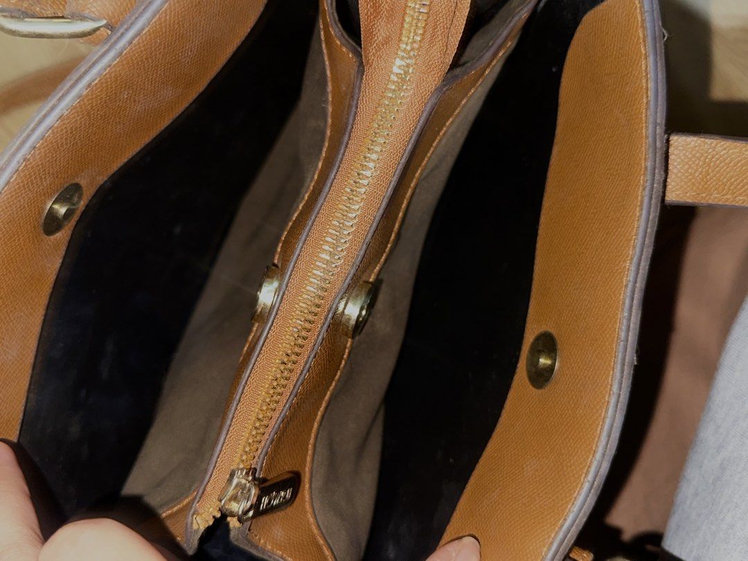 Monogram Pattern Tote Bag with Shoulder Strap (Category: Tote Bags) located in Manila. Submitted by tenshiii185 (Listing ID 1469430826, Image 3). Description: - Design: Stylish brown monogram pattern with faux leather trim - Carrying Options: Dual top handles and an adjustable, removable shoulder strap - Hardware: Elegant gold-tone hardware throughout - Compartments: Central zipped compartment dividing two main sections, plus an extra inner zip p