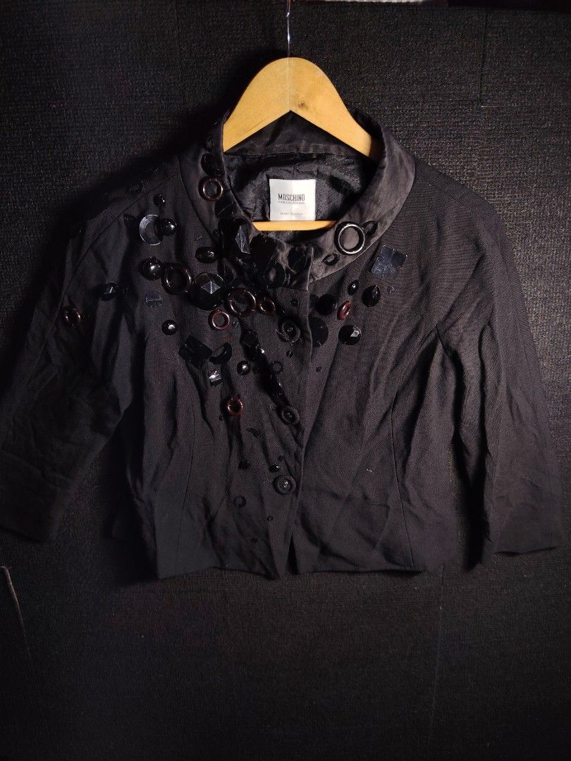 Moschino Cheap and Chic Embellished Wool Jacket (Category: Coats, Jackets and Outerwear) located in Baguio. Submitted by angeloshoppebaguio2600 (Listing ID 1469480885, Image 1). Description: - Brand: Moschino Cheap and Chic - Material: Premium black wool, made in Italy - Design: Front and shoulder decorative bead and button embellishments - Features: Button closure, 3/4 sleeves, and polka dot C patterned lining - Authenticity: Aeffe tag attached 