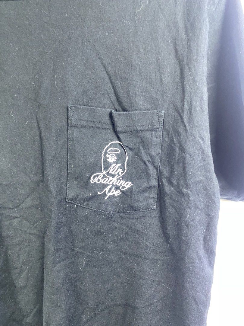 Mr. Bathing Ape Black Pocket Tee Size L (Category: Tshirts & Polo Shirts ) located in Manila. Submitted by declutterpromax (Listing ID 1469450687, Image 2). Description: - Brand: Mr. Bathing Ape - Color: Black - Size: L (Woven neck & size tags intact) - Material/Style: Standard crew neckline, regular hem, short sleeves - Details: Chest pocket with embroidered white ape head logo and signature script - Measurements (laid flat): 19 inches chest wid