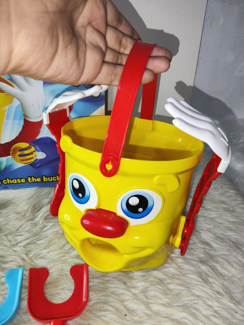 Mr. Bucket Board Game Ideal Toys (Category: Board Games & Puzzles) located in Cavite. Submitted by tinetaclesss (Listing ID 1469498562, Image 3). Description: - Vintage Ideal Mr. Bucket action game with original box - Features motorized yellow bucket with arms and red handle - Includes 4 colored scoop shovels (yellow, green, blue, red) - Comes with 4 matching slotted balls - Perfect for 2 to 4 players, ages 4 and up - Great interactive game for f