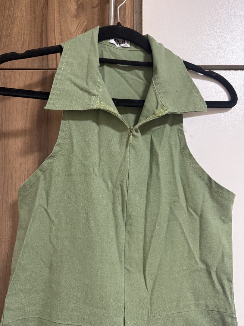 Mu The Label Green Collared Jumpsuit (Category: Jumpsuits) located in Binangonan. Submitted by curatedbyjuys (Listing ID 1469443880, Image 2). Description: - Brand/Style: Miu The Label olive green utility jumpsuit - Design: Sleeveless, pointed collar, front zip closure, and straight-leg cut - Pockets: Includes two functional back pockets - Material: Structured canvas-like fabric - Vibe: Minimalist utility aesthetic, perfect for easy everyday styl