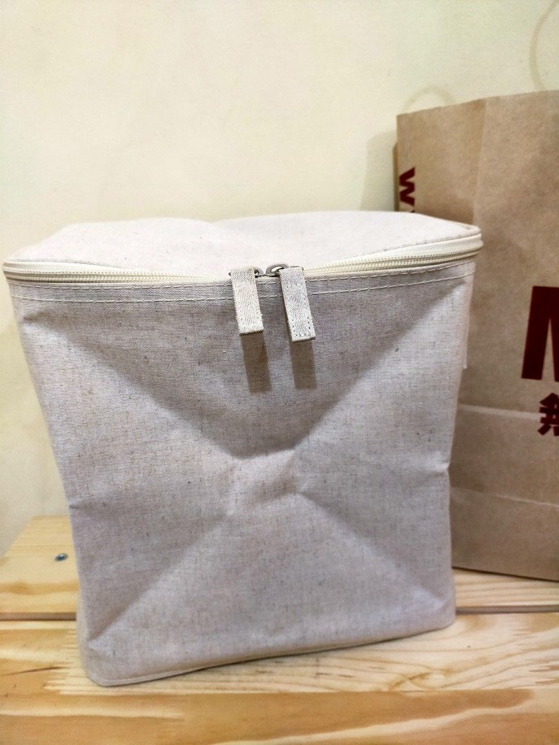 MUJI Foldable Box with Zip Lid (Category: Accessory Holder, Box & Organizers) located in Makati City. Submitted by braveandbold_18 (Listing ID 1469566717, Image 2). Description: - Brand: MUJI - almost new - Material: Cotton linen fabric in versatile neutral beige - Design: Collapsible soft container with a secure zippered top closure - Portability: Equipped with handy side handles for easy lifting and carrying - Space-saving: Folds completely fla