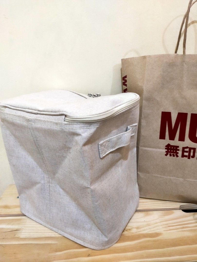 MUJI Foldable Box with Zip Lid (Category: Accessory Holder, Box & Organizers) located in Makati City. Submitted by braveandbold_18 (Listing ID 1469566717, Image 1). Description: - Brand: MUJI - almost new - Material: Cotton linen fabric in versatile neutral beige - Design: Collapsible soft container with a secure zippered top closure - Portability: Equipped with handy side handles for easy lifting and carrying - Space-saving: Folds completely fla