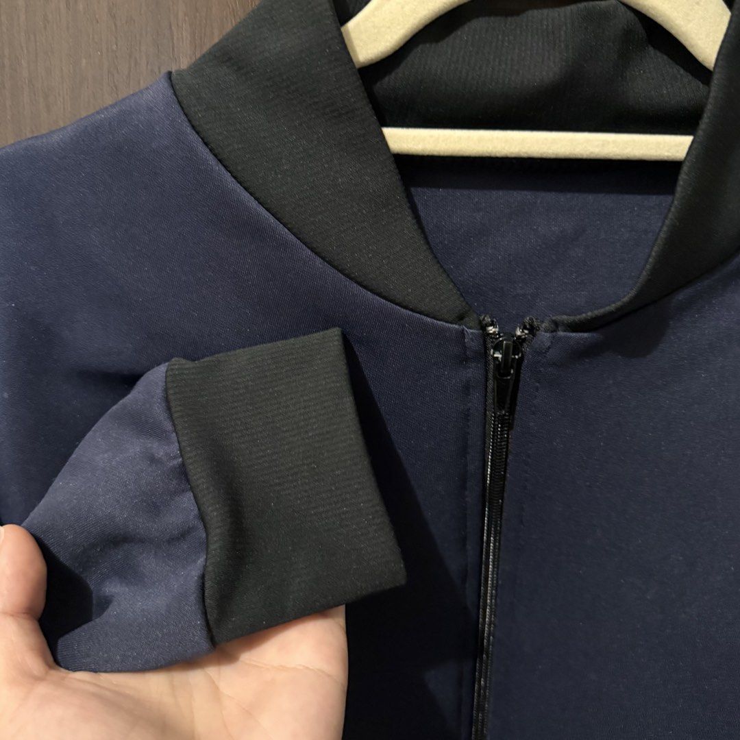 Navy Blue Bomber Jacket with Black Ribbed Trim (Category: Coats, Jackets and Outerwear) located in Quezon City. Submitted by ianne.declutter (Listing ID 1469455413, Image 1). Description: - Color: Dark Navy Blue - Details: Black ribbed collar, cuffs, and hem with full zip closure - Material: Smooth, lightweight fabric with clean stitching - Style: Great everyday outerwear that easily matches casual fits - Condition: Brand new / Excellent .