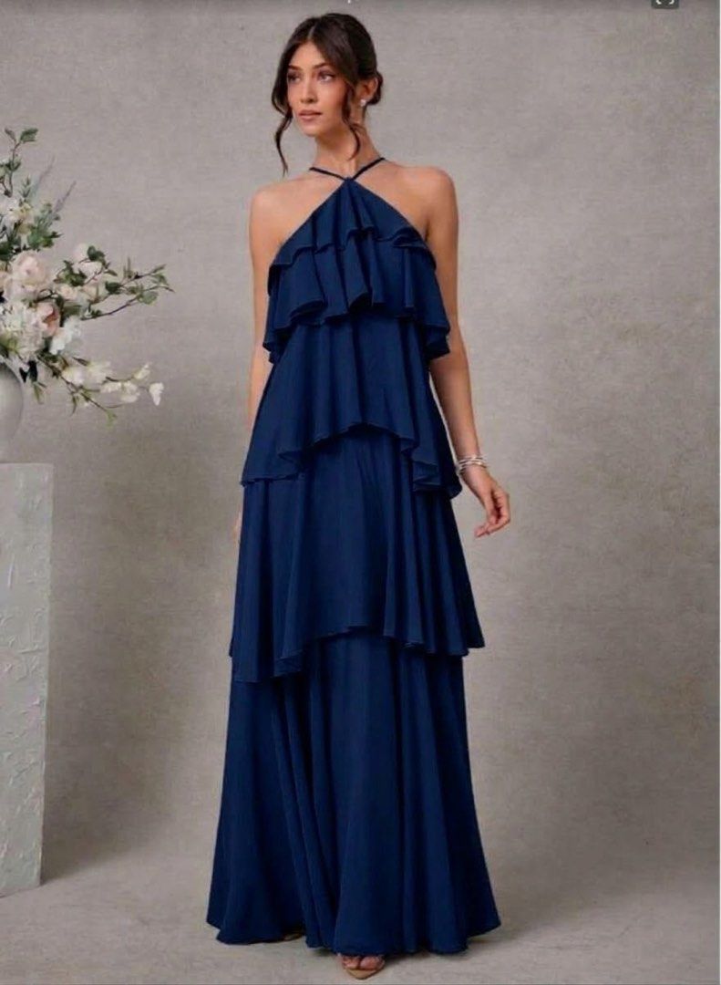 Navy Blue Ruffled Halter Maxi Dress (Category: Dresses) located in Makati City. Submitted by esila.essentials (Listing ID 1469517465, Image 1). Description: FOR RENT - Color: Deep Navy Blue - Style: Halter neck with thin straps and floor-length flowy skirt - Design: Elegant tiered ruffles all over - Fabric: Lightweight and comfortable - Occasion: Perfect for weddings, formal dinners, and evening events - Condition: Excellent / Like new - Shipping