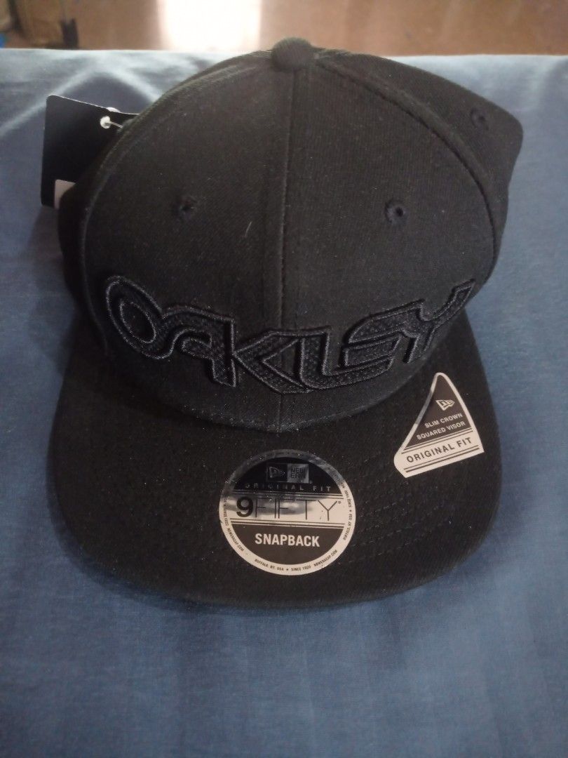 New Era Oakley 9FIFTY Snapback Cap Black B1B FB Hat (Category: Caps & Hats) located in Paranaque City. Submitted by annhua17524 (Listing ID 1469423834, Image 1). Description: - Brand: New Era 9FIFTY x Oakley - Color: Classic Black - Fit: Slim crown with squared visor and original fit - Condition: Brand new with original brim stickers and interior tags intact - US bought.