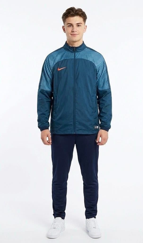 Nike | Track Jacket Windbreaker| Size M (Category: Coats, Jackets and Outerwear) located in Manila. Submitted by bengirlclothing (Listing ID 1469429496, Image 3). Description: - Brand: Nike - Size: Medium (Tag indicates Size M) - Style: Track jacket with full zip and stand collar - Color: Blue with striped sleeves and orange swoosh logo - Material: 100% recycled polyester with breathable mesh lining - Condition: Excellent / Lightweight outerwear 