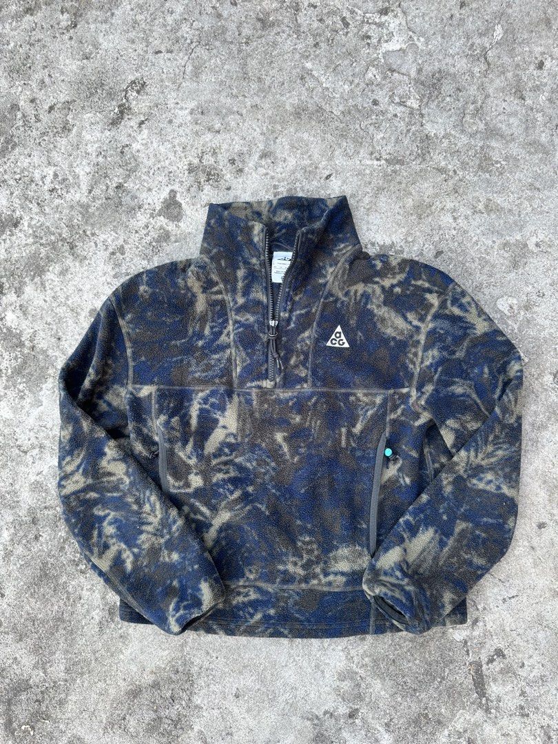 Nike ACG Wolf Tree Therma-FIT Fleece Pullover XS (Category: Coats, Jackets and Outerwear) located in Bago City. Submitted by thekasproject (Listing ID 1469477270, Image 1). Description: - Brand: Nike ACG - Model: Wolf Tree Half-Zip Fleece Pullover (Style DJ1276-437) - Color: Blue and dark grey camouflage - Size: XS - Material: Warm and lightweight Polartec fleece - Features: High collar with zip closure, embroidered ACG triangle logo on chest, zi