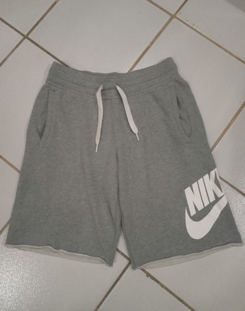 Nike Alumni Grey (Category: Shorts) located in Caloocan City. Submitted by wildmountain.b14159 (Listing ID 1469490150, Image 3). Description: - Brand: Nike - Style: Fleece shorts with raw cut hem - Color: Grey with large white logo - Size: Small - Material: Comfortable cotton blend - Features: Drawstring waistband with white cords and two side pockets - Origin: Made in Malaysia - Condition: Great for casual wear and lounging.