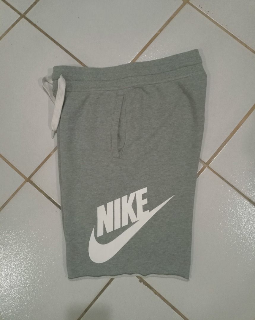 Nike Alumni Grey (Category: Shorts) located in Caloocan City. Submitted by wildmountain.b14159 (Listing ID 1469490150, Image 2). Description: - Brand: Nike - Style: Fleece shorts with raw cut hem - Color: Grey with large white logo - Size: Small - Material: Comfortable cotton blend - Features: Drawstring waistband with white cords and two side pockets - Origin: Made in Malaysia - Condition: Great for casual wear and lounging.