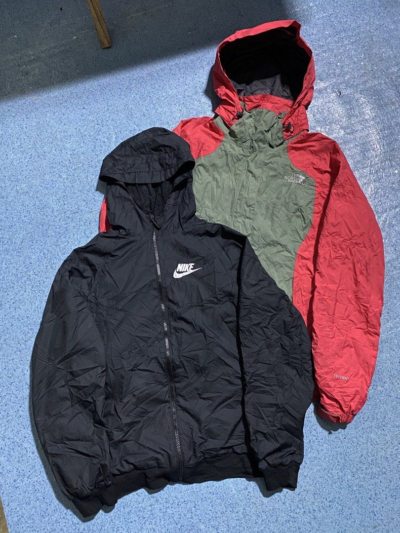 Nike and The North Face Hooded Jackets Bundle (Category: Coats, Jackets and Outerwear) located in Manila. Submitted by jeproxthrift (Listing ID 1469558620, Image 1). Description: - 2-in-1 jacket bundle for layering and outdoor wear - Item 1: Solid black Nike windbreaker with full zip and white chest logo - Item 2: The North Face HyVent jacket in a stylish green and red colorway - Both pieces feature full zip fronts and attached hoods - Perfect fo
