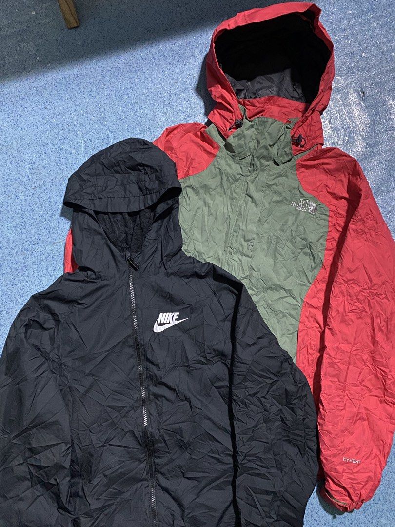 Nike and The North Face Hooded Jackets Bundle (Category: Coats, Jackets and Outerwear) located in Manila. Submitted by jeproxthrift (Listing ID 1469558620, Image 2). Description: - 2-in-1 jacket bundle for layering and outdoor wear - Item 1: Solid black Nike windbreaker with full zip and white chest logo - Item 2: The North Face HyVent jacket in a stylish green and red colorway - Both pieces feature full zip fronts and attached hoods - Perfect fo